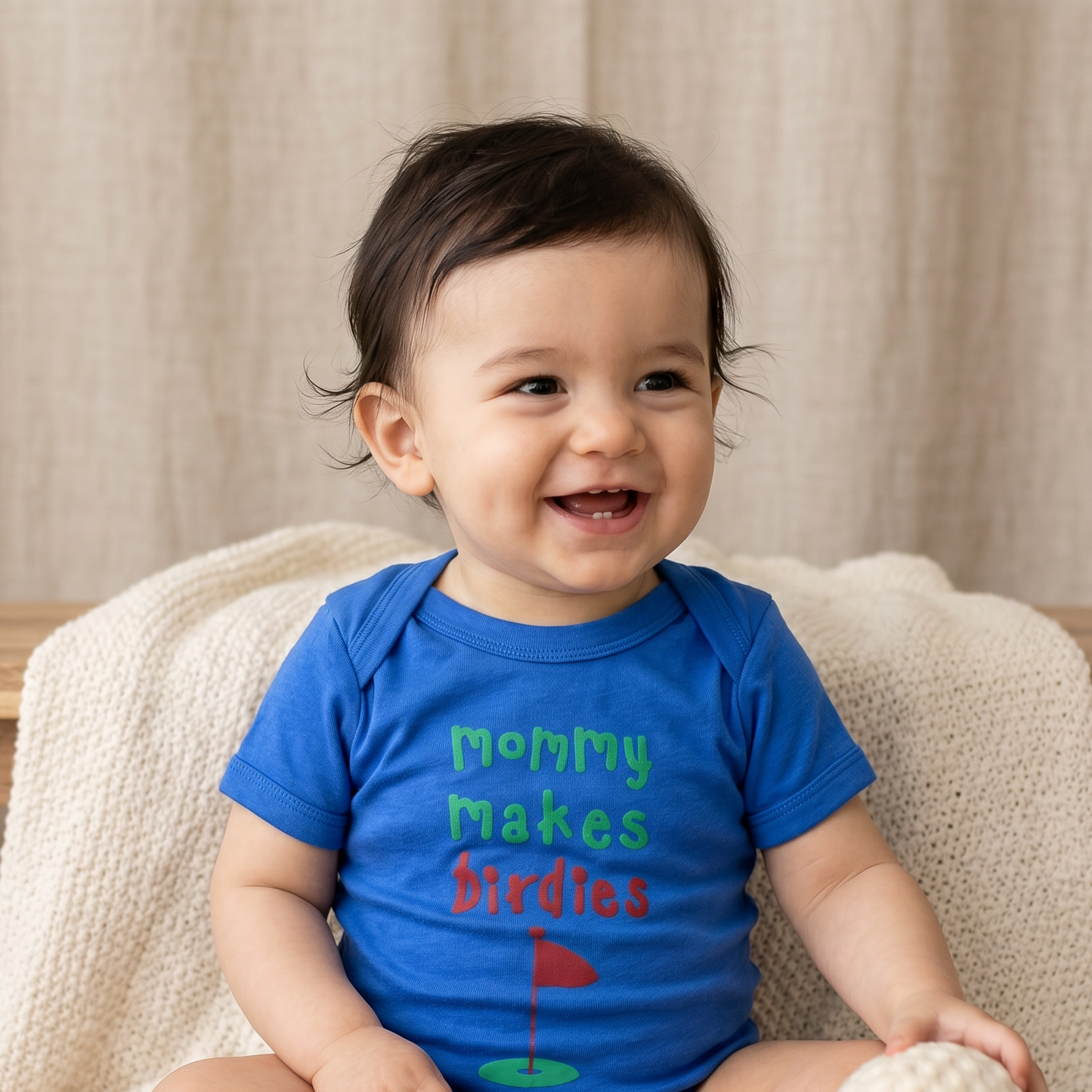 mommy makes birdies text on blue baby clothing onesie 1z worn by dark haired 1 year old baby boy