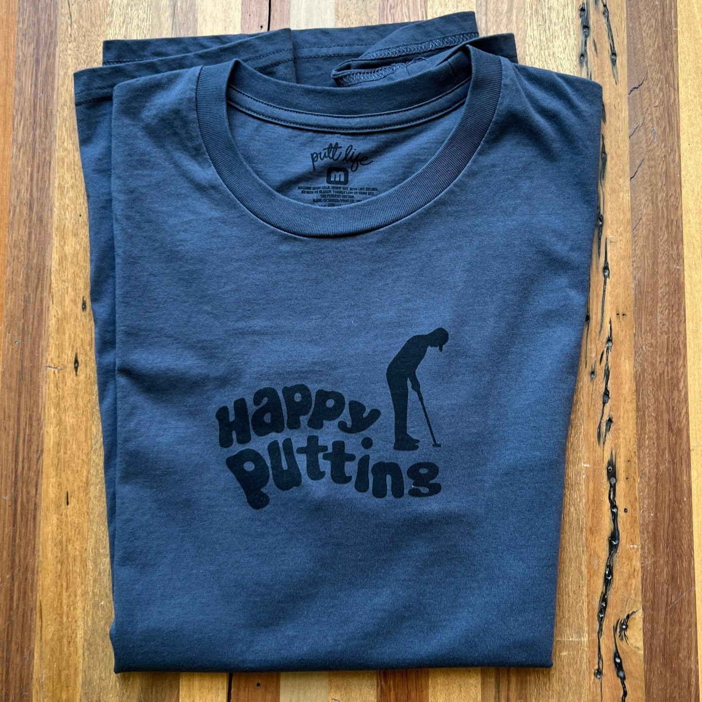 Putt Life Golf navy blue t-shirt with the text 'HAPPY PUTTING' and an illustration of a golfer putting front view