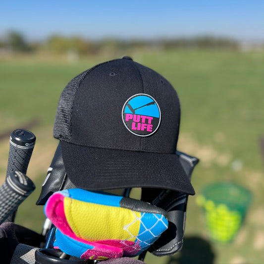 Putt life golf blue and pink putter logo black trucker snapback hat front