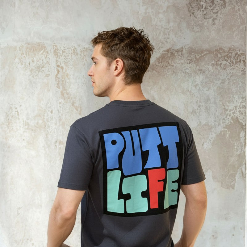 Man wearing a Putt Life Golf navy blue t-shirt with colorful 'PUTT LIFE' text on the back 